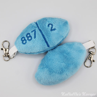 Plush keychain of an estrogen pill