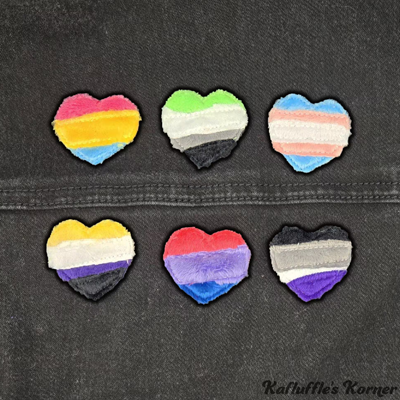 Patches of the Pansexual, Aromantic, Trans, Nonbinary, Bisexual and Asexual flags made from leftover scrap fabric.