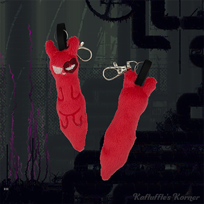 A plush keychain of the slugcat artificer
