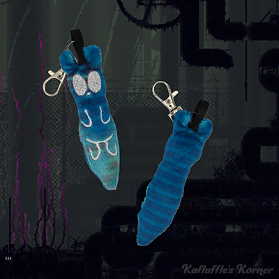 A plush keychain of the slugcat inv